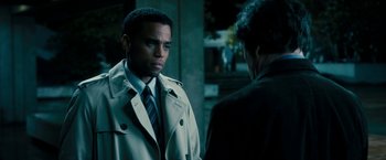 Movie still from “Underworld: Awakening” (2012), directed by Björn Stein – A man in a trench coat and tie standing next to another man; Close Up shot, Over the shoulder angle