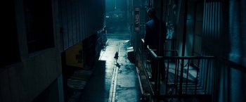 Movie still from “Underworld: Awakening” (2012), directed by Björn Stein – A man walking down a street with a bird on the sidewalk; Extreme Wide shot, High angle