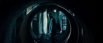 Movie still from “Underworld: Awakening” (2012), directed by Björn Stein – A man standing inside of a large metal pipe; Wide shot, High angle