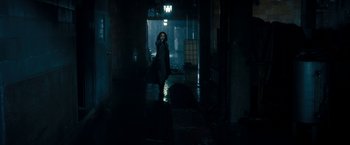 Movie still from “Underworld: Awakening” (2012), directed by Björn Stein – A person walking in the dark in a dark room; Wide shot, Low angle