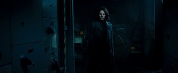 Movie still from “Underworld: Awakening” (2012), directed by Björn Stein – A woman standing in the dark in a dark room; Medium shot, Over the shoulder angle