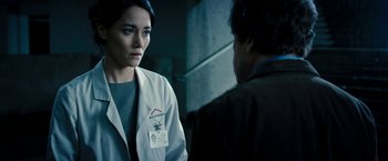Movie still from “Underworld: Awakening” (2012), directed by Björn Stein – A woman wearing a lab coat talking to a man; Close Up shot, Over the shoulder angle