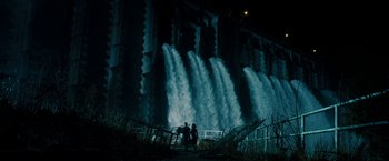 Movie still from “Underworld: Awakening” (2012), directed by Björn Stein – Two people are standing in front of a large waterfall at night; Extreme Wide shot, Low angle