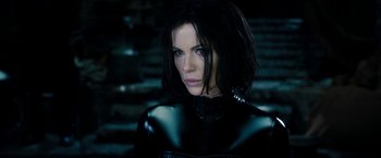 Movie still from “Underworld: Awakening” (2012), directed by Björn Stein – A person wearing a black outfit; Close Up shot, Over the shoulder angle