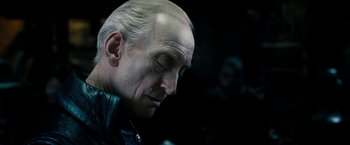 Movie still from “Underworld: Awakening” (2012), directed by Björn Stein – An old man with a bald head and a white beard; Close Up shot, Over the shoulder angle