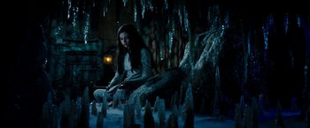 Movie still from “Underworld: Awakening” (2012), directed by Björn Stein – A woman sitting on the ground in front of a bunch of icicles; Wide shot, High angle