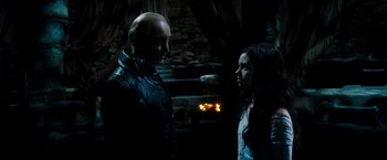 Movie still from “Underworld: Awakening” (2012), directed by Björn Stein – A man and a woman standing next to each other in the dark; Medium shot, Over the shoulder angle