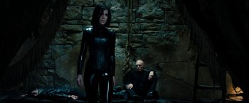 Movie still from “Underworld: Awakening” (2012), directed by Björn Stein – A woman in a catsuit standing next to a man; Medium shot, Low angle