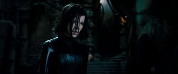 Movie still from “Underworld: Awakening” (2012), directed by Björn Stein – A person wearing a black outfit; Medium shot, Over the shoulder angle