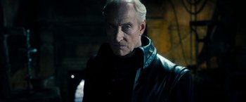 Movie still from “Underworld: Awakening” (2012), directed by Björn Stein – An older man wearing a leather jacket and looking at the camera; Close Up shot, Low angle