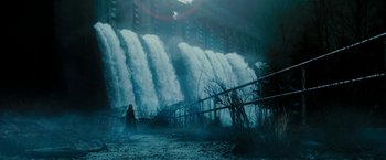 Movie still from “Underworld: Awakening” (2012), directed by Björn Stein – A person standing in front of a large waterfall; Extreme Wide shot, Low angle