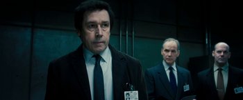Movie still from “Underworld: Awakening” (2012), directed by Björn Stein – A man in a suit and tie standing next to another man in a suit and tie; Close Up shot, Over the shoulder angle