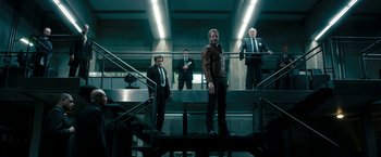 Movie still from “Underworld: Awakening” (2012), directed by Björn Stein – A group of men standing next to each other on some stairs; Wide shot, Low angle