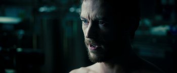 Movie still from “Underworld: Awakening” (2012), directed by Björn Stein – A person with a beard looking at the camera; Close Up shot, Over the shoulder angle