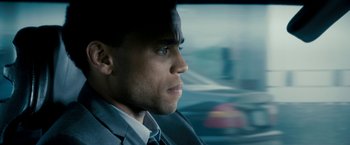 Movie still from “Underworld: Awakening” (2012), directed by Björn Stein – A person wearing a suit driving a car; Close Up shot, Over the shoulder angle