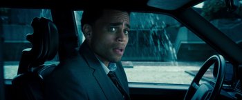 Movie still from “Underworld: Awakening” (2012), directed by Björn Stein – A man wearing a suit and tie driving a car; Close Up shot, Over the shoulder angle