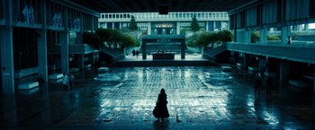 Movie still from “Underworld: Awakening” (2012), directed by Björn Stein – A woman sitting on a tiled floor in a building; Extreme Wide shot, High angle