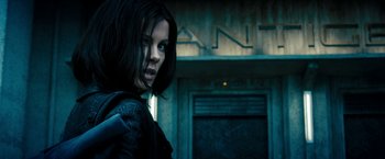 Movie still from “Underworld: Awakening” (2012), directed by Björn Stein – A person wearing a leather jacket; Medium shot, Low angle
