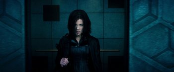 Movie still from “Underworld: Awakening” (2012), directed by Björn Stein – A woman wearing a black leather jacket; Medium shot, Low angle