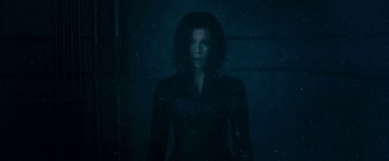Movie still from “Underworld: Awakening” (2012), directed by Björn Stein – A woman standing in the dark in front of a wall; Medium shot, Low angle