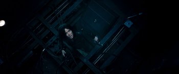 Movie still from “Underworld: Awakening” (2012), directed by Björn Stein – A woman in a dark room holding a gun; Medium shot, Overhead angle