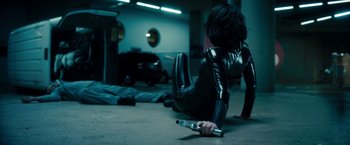 Movie still from “Underworld: Awakening” (2012), directed by Björn Stein – A woman in a black outfit holding a metal object; Wide shot, High angle