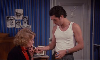 Movie still from “A Room in Town” (1982), directed by Jacques Demy – A man and a woman are looking at each other; Medium shot, High angle