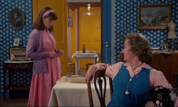 Movie still from “A Room in Town” (1982), directed by Jacques Demy – Two women sitting at a table in front of a table; Medium shot, Over the shoulder angle
