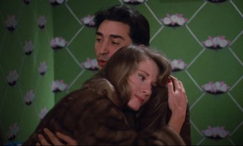 Movie still from “A Room in Town” (1982), directed by Jacques Demy – A man and a woman hugging in a room; Close Up shot, High angle