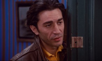 Movie still from “A Room in Town” (1982), directed by Jacques Demy – A person wearing a leather jacket; Close Up shot, Low angle