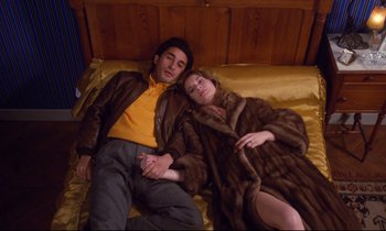 Movie still from “A Room in Town” (1982), directed by Jacques Demy – A man and a woman are sleeping on a bed; Medium shot, Overhead angle