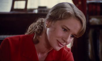 Movie still from “A Room in Town” (1982), directed by Jacques Demy – A woman in a red shirt is looking to her left; Close Up shot, Low angle