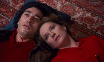 Movie still from “A Room in Town” (1982), directed by Jacques Demy – A man and a woman laying on the ground; Close Up shot, Overhead angle