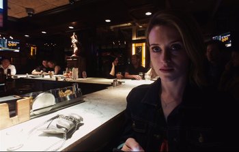 Movie still from “Unsane” (2018), directed by Steven Soderbergh – A woman sitting at a counter in front of a mirror; Close Up shot, Over the shoulder angle