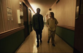 Movie still from “Unsane” (2018), directed by Steven Soderbergh – A man and a woman are walking down a hallway; Wide shot, Low angle