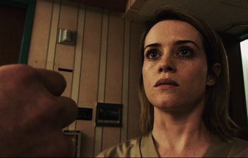 Movie still from “Unsane” (2018), directed by Steven Soderbergh – A person holding something in their hand; Close Up shot, Low angle