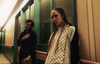 Movie still from “Unsane” (2018), directed by Steven Soderbergh – A man and a woman standing next to each other; Medium shot, Low angle