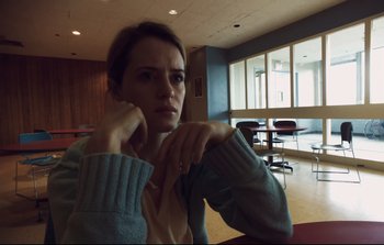 Movie still from “Unsane” (2018), directed by Steven Soderbergh – A woman sitting at a table in a room; Close Up shot, Low angle
