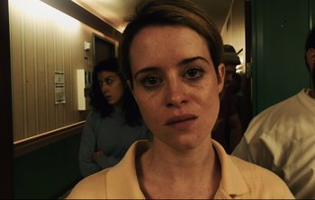 Movie still from “Unsane” (2018), directed by Steven Soderbergh – A woman in a yellow shirt is in a hallway; Close Up shot, Low angle