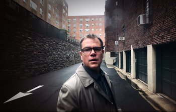 Movie still from “Unsane” (2018), directed by Steven Soderbergh – A man standing on a street in front of a building; Close Up shot, Low angle
