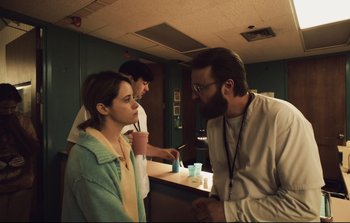Movie still from “Unsane” (2018), directed by Steven Soderbergh – A man and a woman talking to another man; Medium shot, Over the shoulder angle