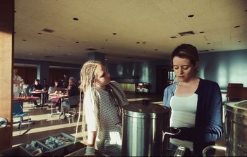 Movie still from “Unsane” (2018), directed by Steven Soderbergh – Two women standing next to each other in a room; Medium shot, Low angle