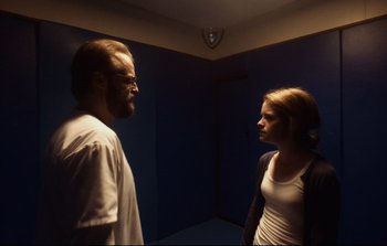 Movie still from “Unsane” (2018), directed by Steven Soderbergh – A man and a woman standing next to each other in a room; Medium shot, Low angle