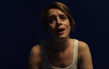Movie still from “Unsane” (2018), directed by Steven Soderbergh – A woman with a surprised look on her face; Close Up shot, Over the shoulder angle