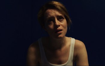 Movie still from “Unsane” (2018), directed by Steven Soderbergh – A young woman is looking at the camera; Close Up shot, Low angle