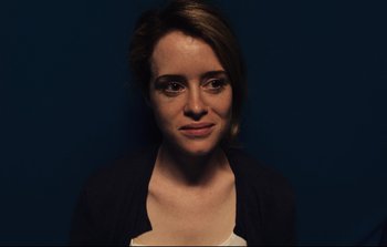 Movie still from “Unsane” (2018), directed by Steven Soderbergh – A young woman is posing for a picture; Close Up shot, Overhead angle