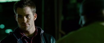 Movie still from “Unstoppable” (2010), directed by Tony Scott – A man in a leather jacket is looking to his left; Close Up shot, Over the shoulder angle