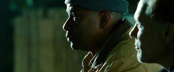 Movie still from “Unstoppable” (2010), directed by Tony Scott – A person wearing a hat and a jacket; Close Up shot, Low angle