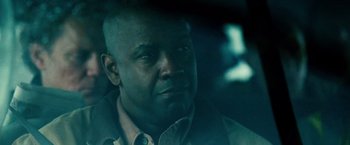 Movie still from “Unstoppable” (2010), directed by Tony Scott – A man with a bald head is sitting in a car; Close Up shot, Low angle