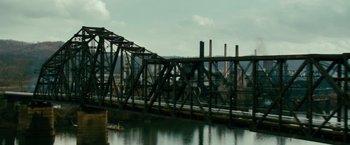 Movie still from “Unstoppable” (2010), directed by Tony Scott – A train crossing a bridge over a body of water; Extreme Wide shot, High angle